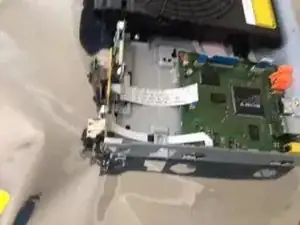 Remove the screw from the USB header/ IR receiver daughterboard. (On the front).